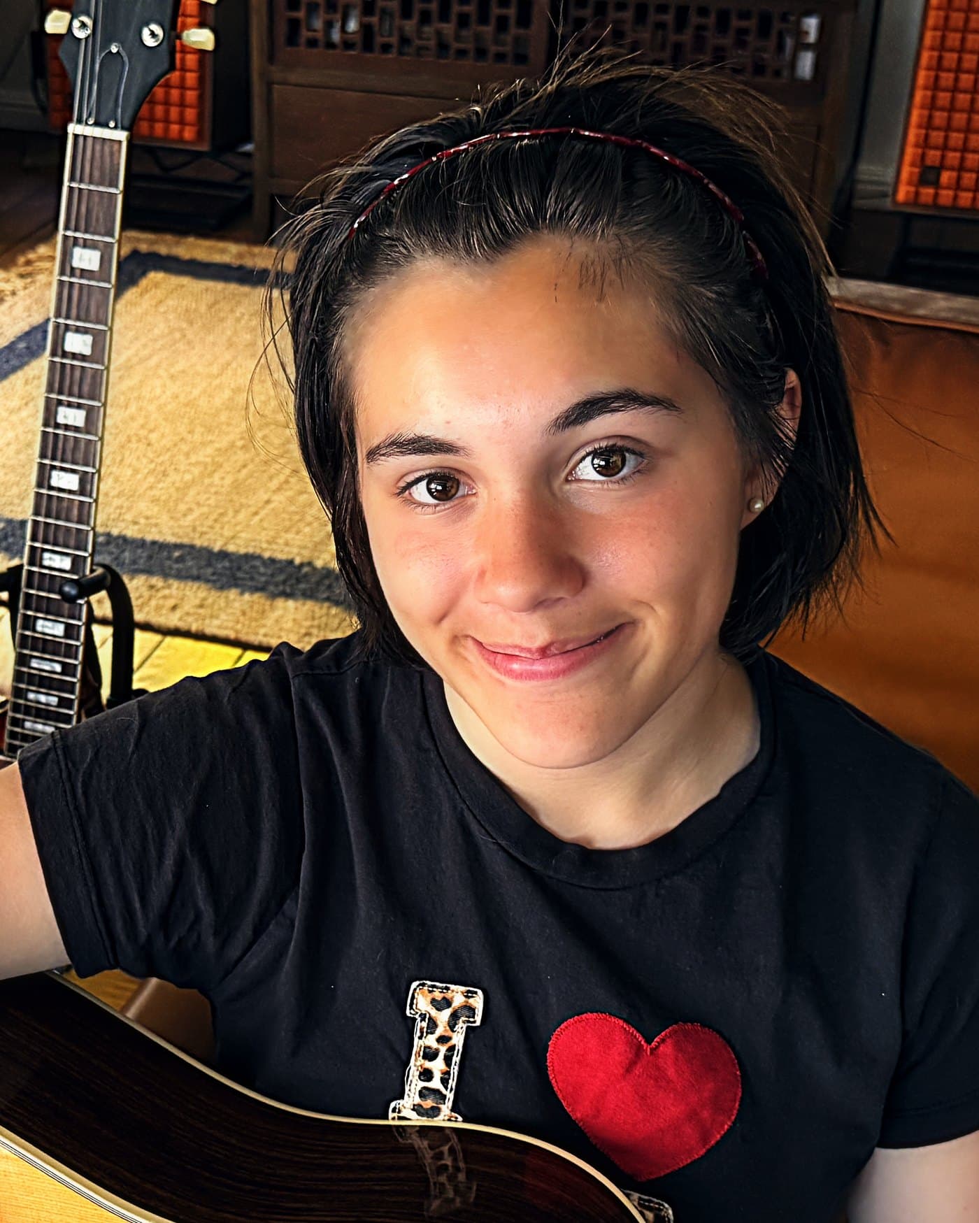 Sloane holding an acoustic guitar